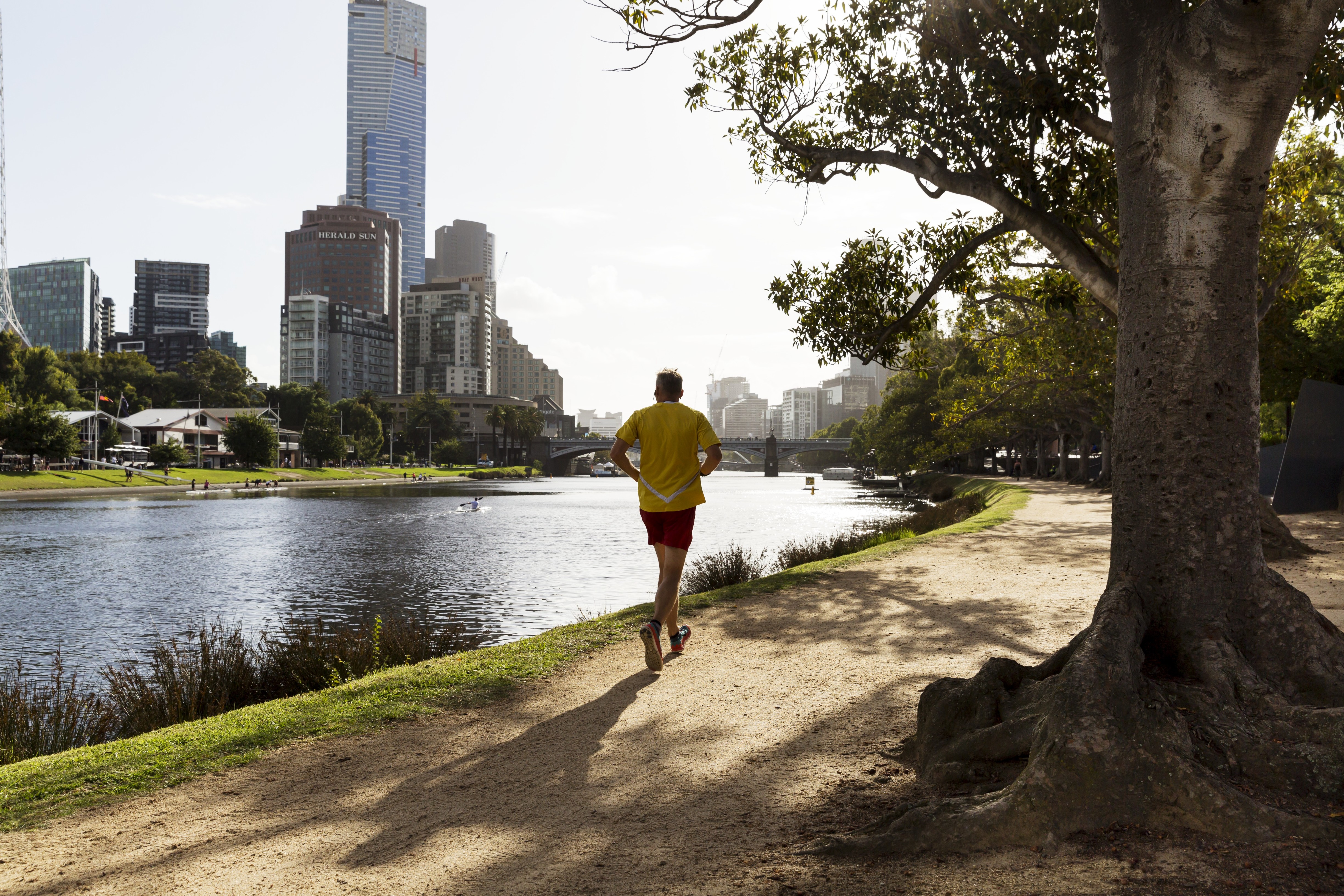 A photo of a person running along the Birrarung (Yarra River), Victoria